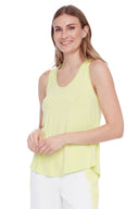 Model wearing the Agnes Bamboo Racerback Tank 2.0 in Lime, front view.