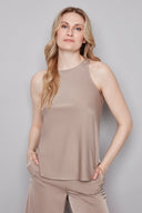 Model wearing the Luna Belize almond Satin Tank Top in Almond, featuring a higher neckline and curved fishtail hem, front view.