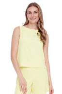 Model wearing the Gianna Vegan Silk Tank in Lime, featuring a higher neckline, slim fit, and subtle seam detailing, front view.