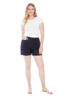 Model wearing the Elizabeth Solid Techno Pocket Short in Navy, featuring oversized front pockets, a pull-on waistband, and a flattering slim fit, front view.