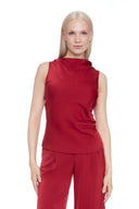 Model wearing the Veronica Belize Satin Sleeveless Top in Lava, featuring a high neckline and sleek satin finish, front view.