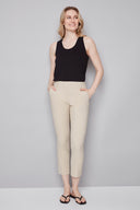 Model wearing the Chloe Techno Slim Ankle Pant in Sand, featuring a slim ankle silhouette and pull-on design, front view.