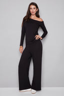Model wearing the Sandy Provence Wide-Leg Full-Length Pant in Black, featuring a relaxed wide-leg silhouette and exposed front seam detailing, front view.