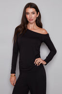 Model wearing the Claude Provence Drop-Shoulder Top in Black, featuring an asymmetrical one-shoulder neckline, long sleeves, and subtle ruching, front view.