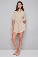 Model wearing the Nora Air Flow Lounge Short in Cashew, featuring a relaxed fit, tie-front waistband, and asymmetrical hem, front view.