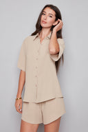 Model wearing the Presley Air Flow Button-Down Top in Cashew, featuring a slim fit, short sleeves, and classic button-front design, front view.