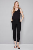 Model wearing the Chloe Techno Slim Ankle Pant in Black, featuring a slim ankle silhouette and pull-on design, front view.