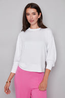 Model wearing the Alessia Provence Sweatshirt in White, featuring a relaxed fit, crew neckline, and dropped shoulders, front view.