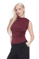 Model wearing the Veronica Provence Top in Merlot, featuring a high neckline and sleek sleeveless silhouette, front view.