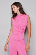 Model wearing the Veronica Provence Top in Cherry, featuring a high neckline and sleek sleeveless silhouette, front view.