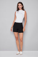Model wearing the Lisa Techno Short in Black, featuring a mid-rise pull-on waistband, angled side pockets, and a tailored slim fit, front view.