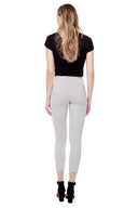 Model wearing the Gwyneth Stix Ankle Pant in Stix Black, back view.