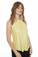 Model wearing the Luna Belize Satin Tank Top in Honey, featuring a higher neckline and curved fishtail hem, front view.