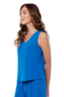 Model wearing the Dani Vegan Silk Sleeveless Top in Cobalt, side view.