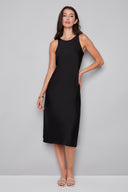 Model wearing the Daphne Belize Satin Sleeveless Dress in Black, featuring a high crew neckline and flowy A-line silhouette, front view.