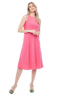 Model wearing the Daphne Belize Satin Sleeveless Dress in Fuschia, featuring a high crew neckline and flowy A-line silhouette, front view.
