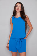 Model wearing the Gianna Vegan Silk Tank in Breeze, featuring a higher neckline, slim fit, and subtle seam detailing, front view.