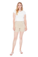 Model wearing the Elizabeth Solid Techno Pocket Short in Stone, featuring oversized front pockets, a pull-on waistband, and a flattering slim fit, front view.