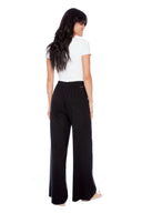 Model wearing the Isla Linen Wide Leg Pant in Black, back view.