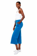 Model wearing the Carrie Light Ponte Wide-Leg Cropped Pant in Sapphire Blue, side view.
