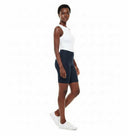 Model wearing the Vicky Waxed Biker Short in Navy, side view.