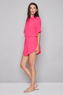 Side view of model wearing the Nora raspberry Air Flow Lounge Short, showcasing the airy silhouette and higher side hem.