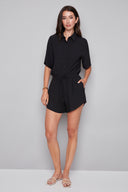 Model wearing the Nora Air Flow Lounge Short in Black, featuring a relaxed fit, tie-front waistband, and asymmetrical hem, front view.