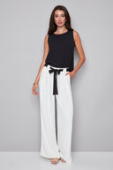 Model wearing the Fiona cream Vegan Silk Belted Wide Leg Pant in White, featuring a pleated waist, contrast tie sash belt, and relaxed wide-leg silhouette, front view.