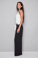 Side view of model wearing the Fiona Vegan Silk Belted Wide Leg Pant in Black with a flowing wide-leg silhouette and tie-front sash detail.