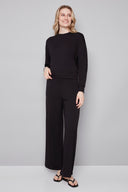 Model wearing the Alessia Provence Sweatshirt in Black, featuring a relaxed fit, crew neckline, and dropped shoulders, front view.