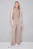Model wearing the Fiona Belize Satin Wide Leg Pant in Almond, featuring a relaxed satin wide-leg silhouette and easy slip-on design, front view.