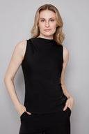 Model wearing the Veronica Belize Satin Sleeveless Top in Black, featuring a high neckline and sleek satin finish, front view.
