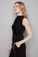 Side view of model wearing the Veronica Belize black Satin Sleeveless Top, showcasing the fluid satin drape and streamlined silhouette.