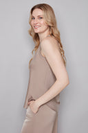 Side view of model wearing the Veronica Belize almond Satin Sleeveless Top, showcasing the fluid satin drape and streamlined silhouette.