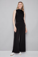 Model wearing the Fiona Belize Satin Wide Leg Pant in Black, featuring a relaxed satin wide-leg silhouette and easy slip-on design, front view.