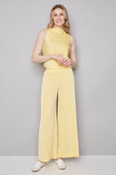 Model wearing the Fiona Belize Satin Wide Leg Pant in Honey, featuring a relaxed satin wide-leg silhouette and easy slip-on design, front view.