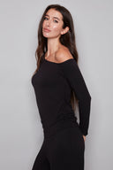 Side view of model wearing the Claude black Provence Drop-Shoulder Top, showcasing the elegant asymmetrical silhouette and soft draping.
