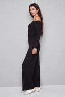 Side view of model wearing the Sandy Provence Wide-Leg Full-Length Pant in Black with a full-length relaxed fit and wide-leg silhouette.