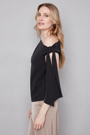 Side view of model wearing the Angel Vegan Silk Tie-Shoulder Top, showcasing the elegant drape and asymmetrical silhouette.