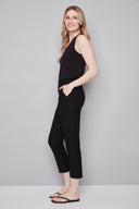 Model wearing the Chloe Techno Slim Ankle Pant in Black, featuring a slim ankle silhouette and pull-on design, side view.