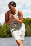 Front view of model wearing the Zandaya French Terry Tank Dress in light grey melange with a sleeveless tank silhouette, scoop neckline, and side pockets.