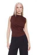 Model wearing the Veronica brown Provence Top in Brown, featuring a high neckline and sleek sleeveless silhouette, front view.